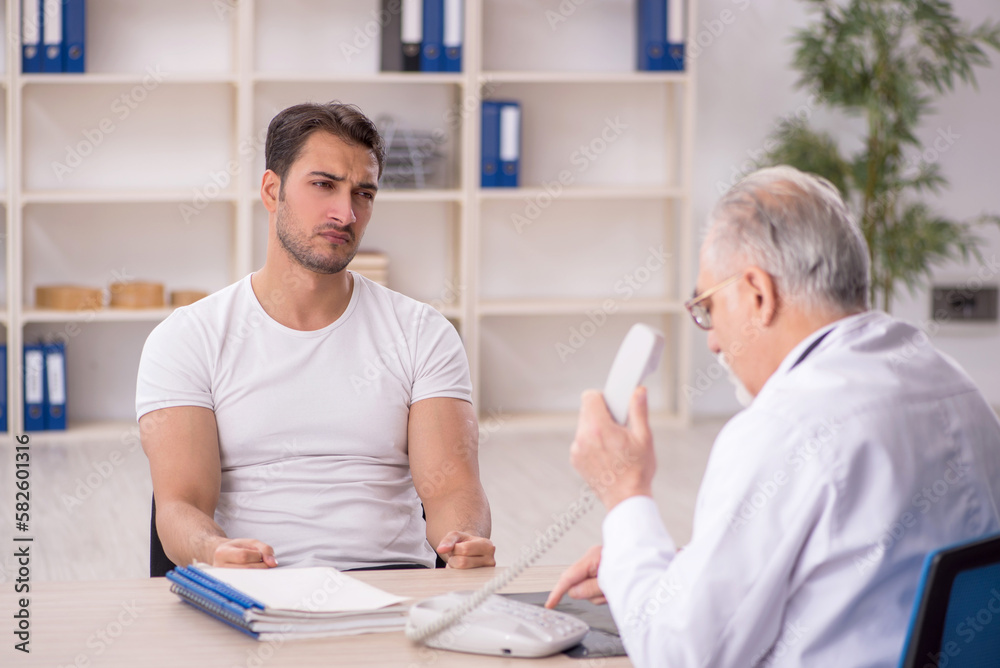 Young male patient visiting old male doctor