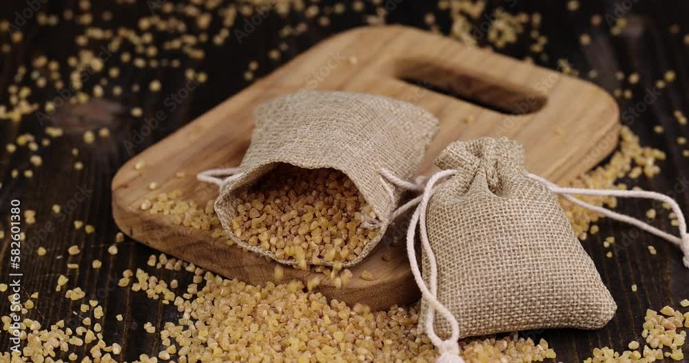 Pour and serve raw wheat porridge, crushed wheat grain for cooking porridge