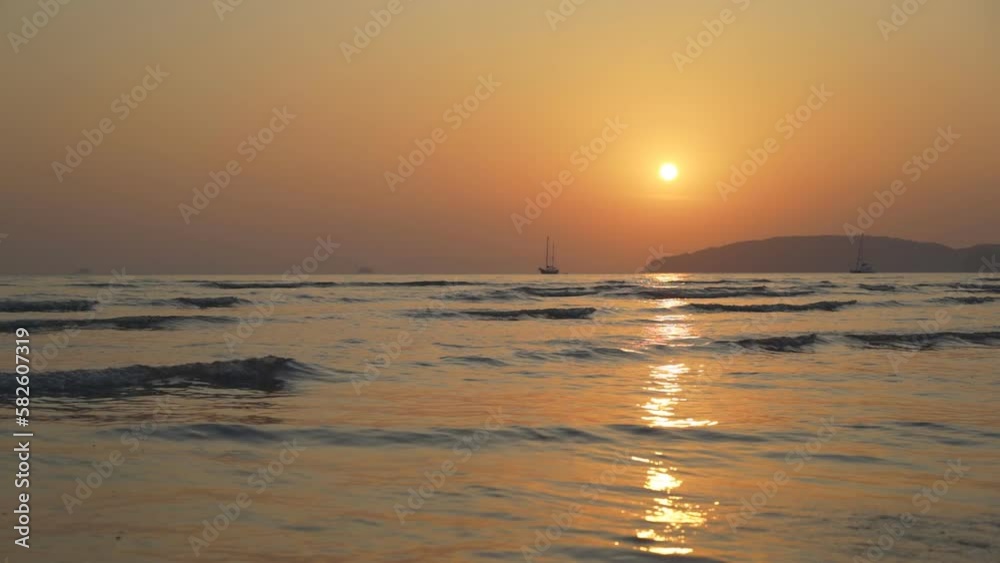nature sunset or sunrise on sea ocean and slow wave with golden sky water or orange warm sun light with fishing boat or ship marine and island mountain for summer seascape at ao nang krabi in thailand