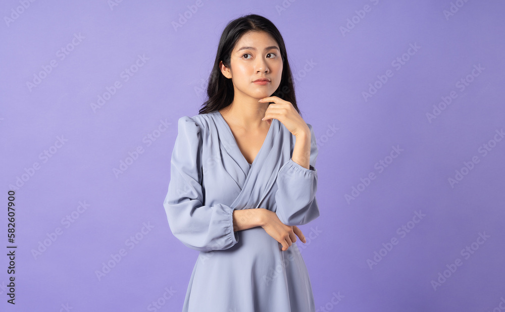 Asian girl in blue dress on purple background Asian girl in blue dress on purple background