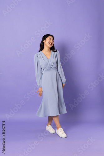 Asian girl in blue dress on purple background