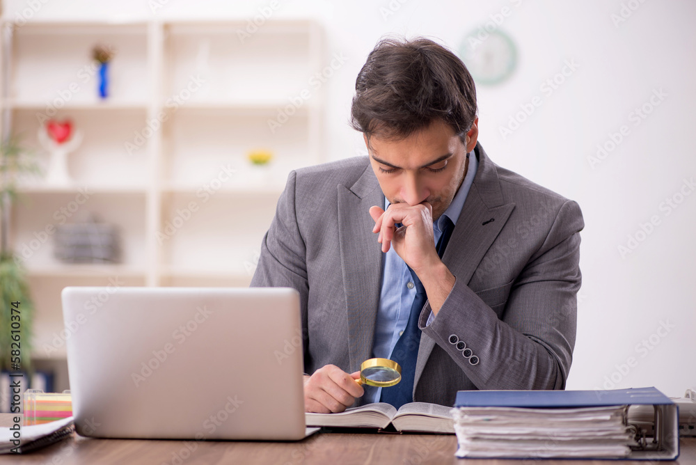 Young male employee working in the office Young male employee working in the office