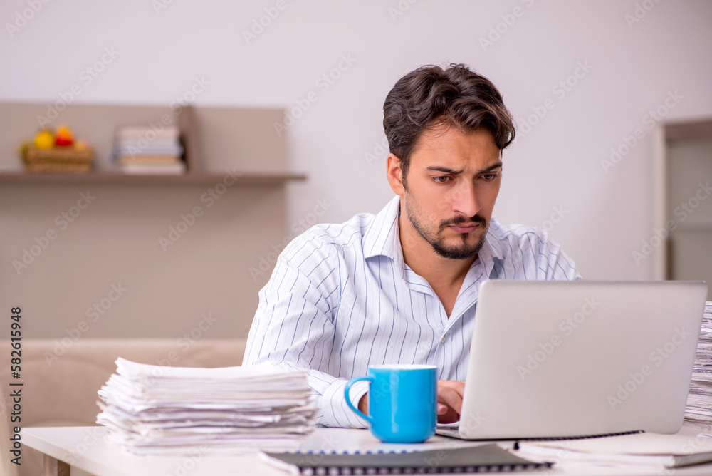 Young businessman employee working from home during pandemic Young businessman employee working from home during pandemic