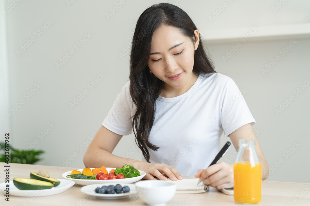 the person planning daily menu during dieting and writing diary to motivate.