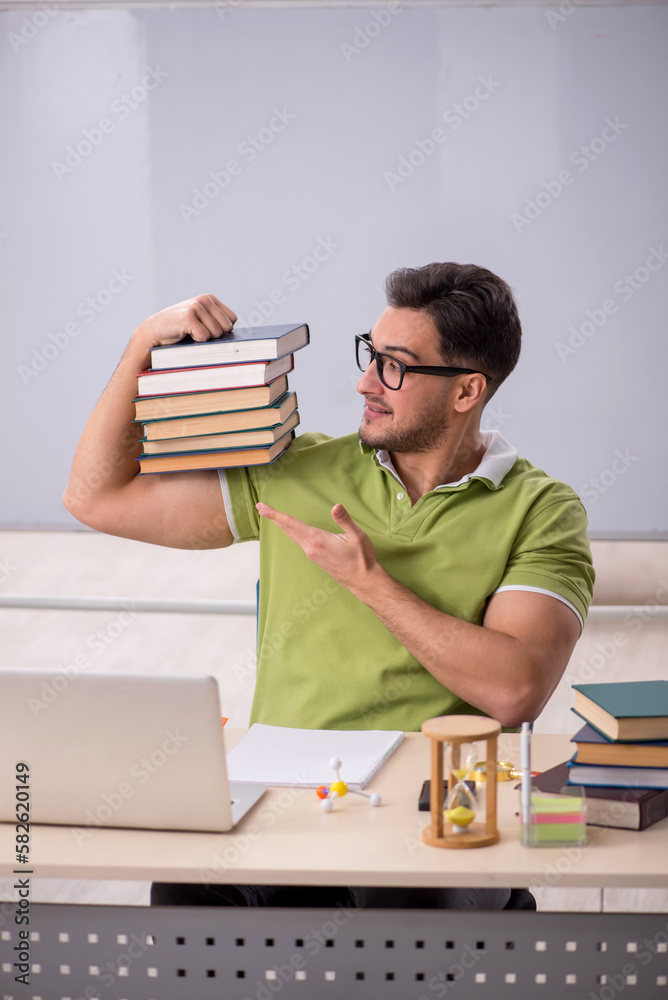 Young male student preparing for exams in the classroom Young male student preparing for exams in the classroom