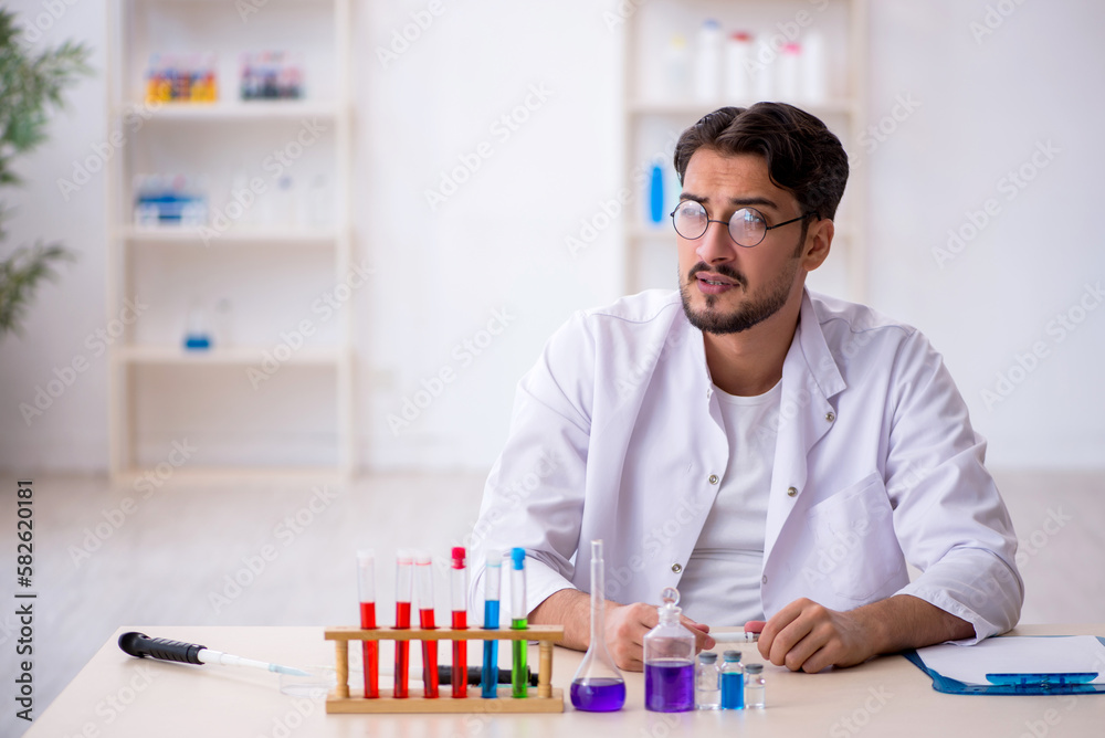 Young male chemist working at the lab Young male chemist working at the lab