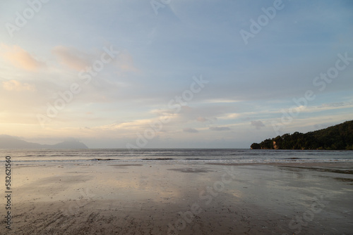 Bako national park, sea sandy beach, overcast, cloudy sunset, sky and sea, low tide. Vacation, travel, tropics concept, Malaysia