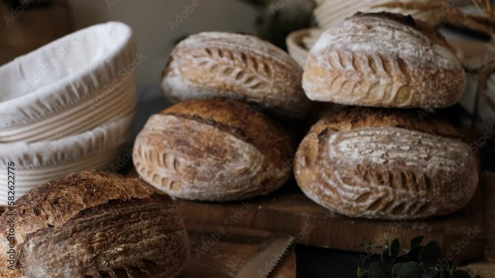 Artisan Batard Sourdough healthy Bread with leaf scoring. Open crumb high hydration Sourdough bread set on table. Artisan Batard Sourdough healthy Bread with leaf scoring. Open crumb high hydration Sourdough bread set on table.