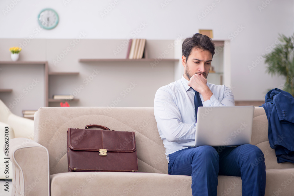 Young male employee working from home during pandemic Young male employee working from home during pandemic