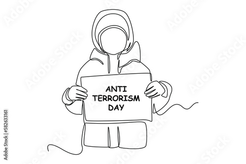 Single one-line drawing child in a thick jacket holding an anti-terrorism day paper. Anti-terrorism day concept continuous line draw design graphic vector illustration