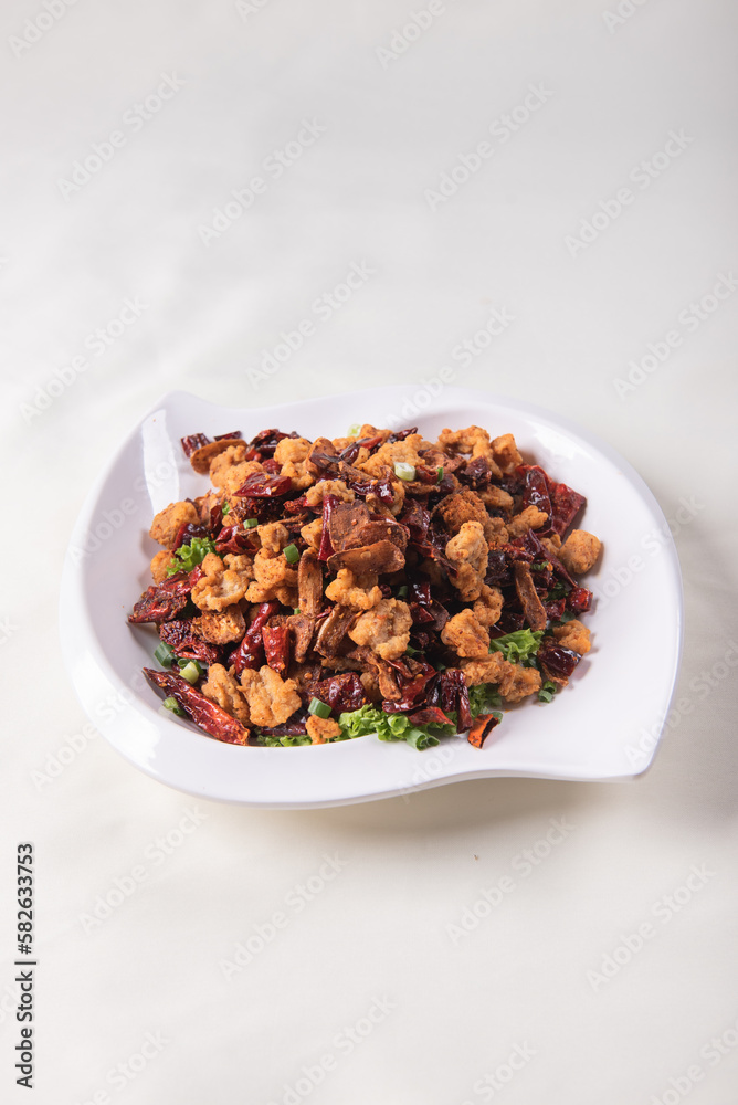 wok fried chicken cube meat with spicy hot dry chilli in Szechuan style on red white cloth asian chinese banquet halal menu wok fried chicken cube meat with spicy hot dry chilli in Szechuan style on red white cloth asian chinese banquet halal menu