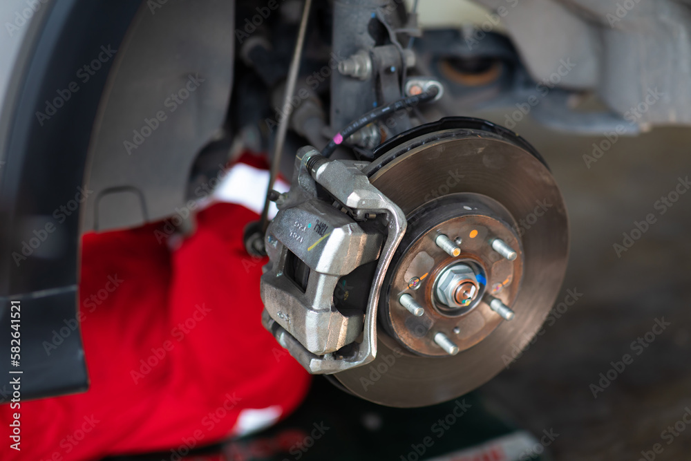 Old Car brake part at car service station garage. car brake disc without wheels Old Car brake part at car service station garage. car brake disc without wheels