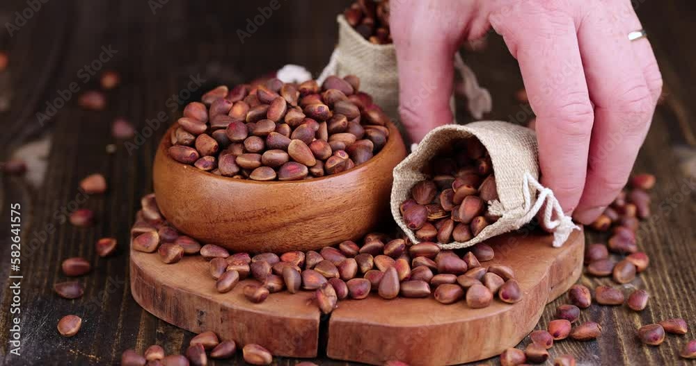 Unpeeled pine nuts after harvest, useful cedar nuts, unpeeled in a hard shell