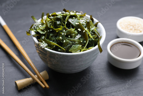 Fresh laminaria (kelp) seaweed served on black table