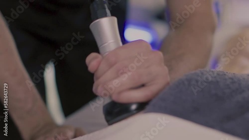 Male masseur make anti-cellulite vacuum massage for young caucasian woman leg in luxury resort spa salon for body relaxation and skin care. Slow motion footage, close-up.