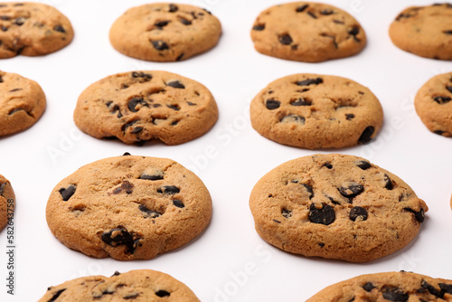 Many delicious chocolate chip cookies on white background, closeup