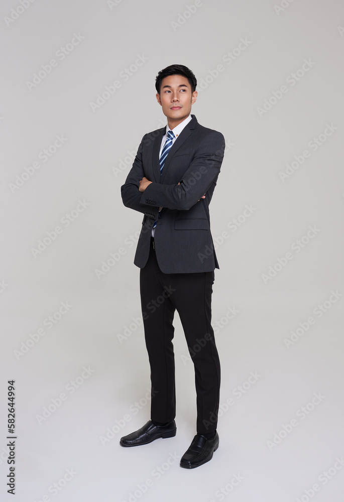 business, people good looking in studio. Full length Asian businessman in grey suit confident with crossed arms on white background. business, people good looking in studio. Full length Asian businessman in grey suit confident with crossed arms on white background.