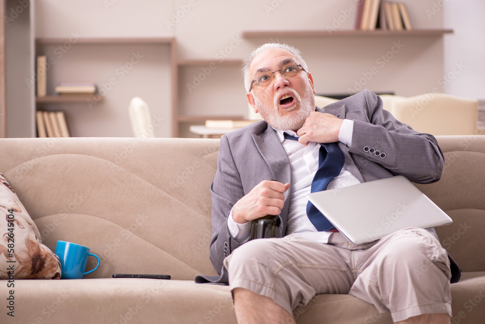 Old male employee working from home during pandemic Old male employee working from home during pandemic