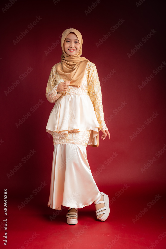 Portrait of a beautiful Asian Muslim female model wearing hijabwear with at a studio photoshoot. Modern hijab fashion and beauty concept