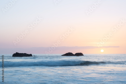 sunset over the ocean with rocks. west coast of the island of La Palma, Spain