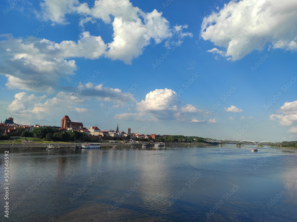 View of Old City of Torun. Vistula (Wisla) river against the backdrop of the historical buildings of the medieval city of Torun. Poland.
