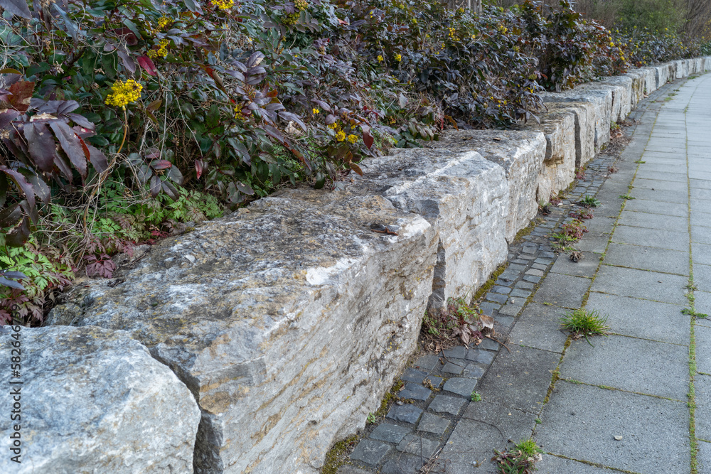 low granite wall on the sidewalk