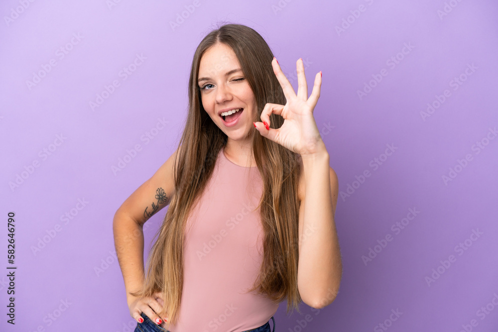 Young Lithuanian woman isolated on purple background showing ok sign with fingers Young Lithuanian woman isolated on purple background showing ok sign with fingers