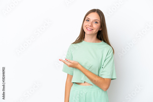 Young Lithuanian woman isolated on white background presenting an idea while looking smiling towards