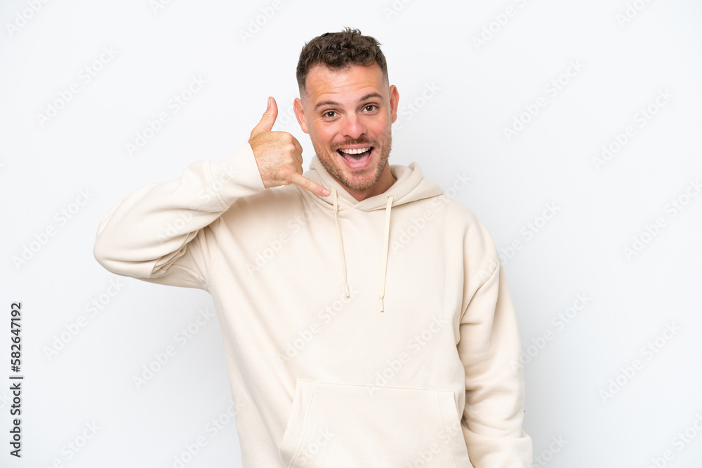 Young caucasian handsome man isolated on white background making phone gesture. Call me back sign Young caucasian handsome man isolated on white background making phone gesture. Call me back sign