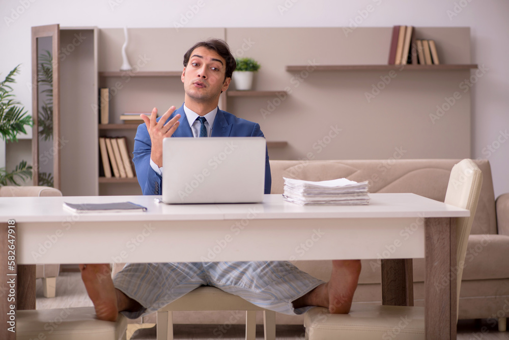 Young male employee working from home during pandemic Young male employee working from home during pandemic