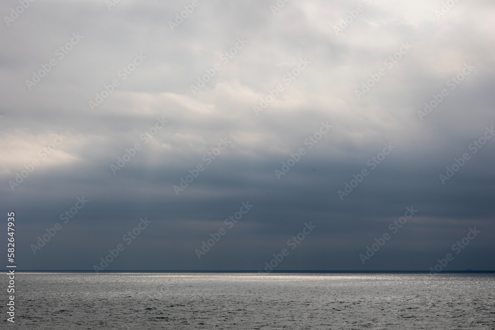 black clouds and sea and light
