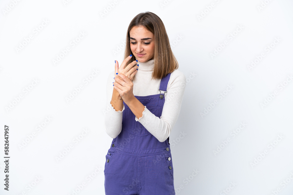 Young caucasian woman isolated on white background suffering from pain in hands Young caucasian woman isolated on white background suffering from pain in hands