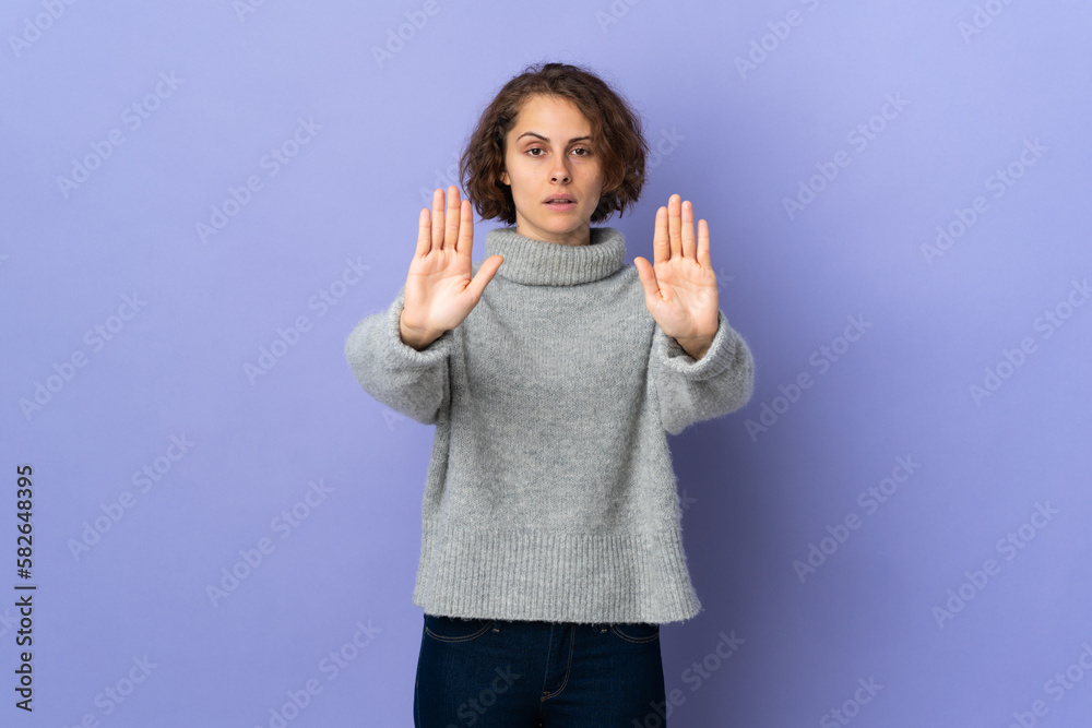 Young English woman isolated on purple background making stop gesture and disappointed Young English woman isolated on purple background making stop gesture and disappointed