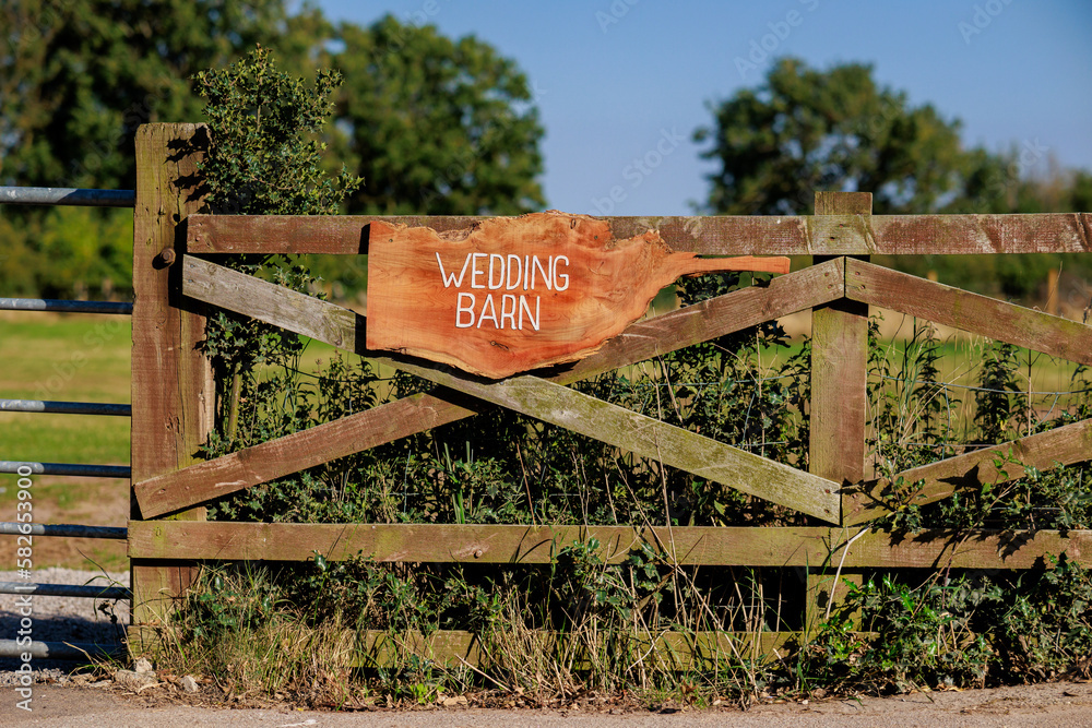 Wedding barn sign at a farm venue in sunshine