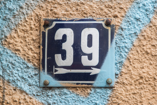 Weathered grunge square metal enameled plate of number of street address with number 39