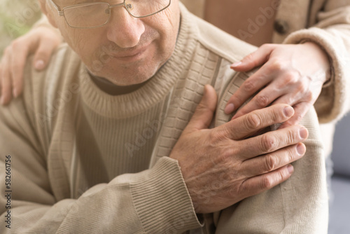 Fotografija Two people holding hand together. elderly man and support woman