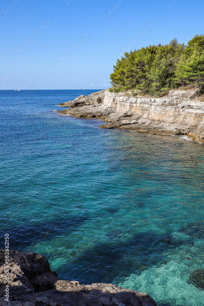 Vertical Landscape of Turquoise Adriatic Sea with Rocky Cliff in Pula. Summer Scenery with Blue Water in Croatia.