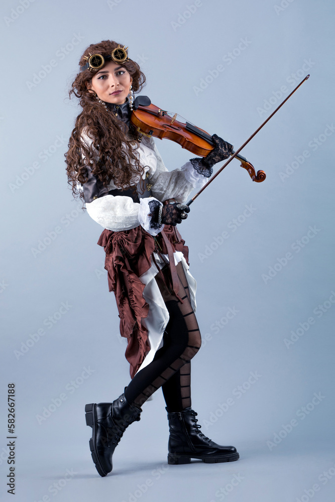 Country girl with violin on the grey background.