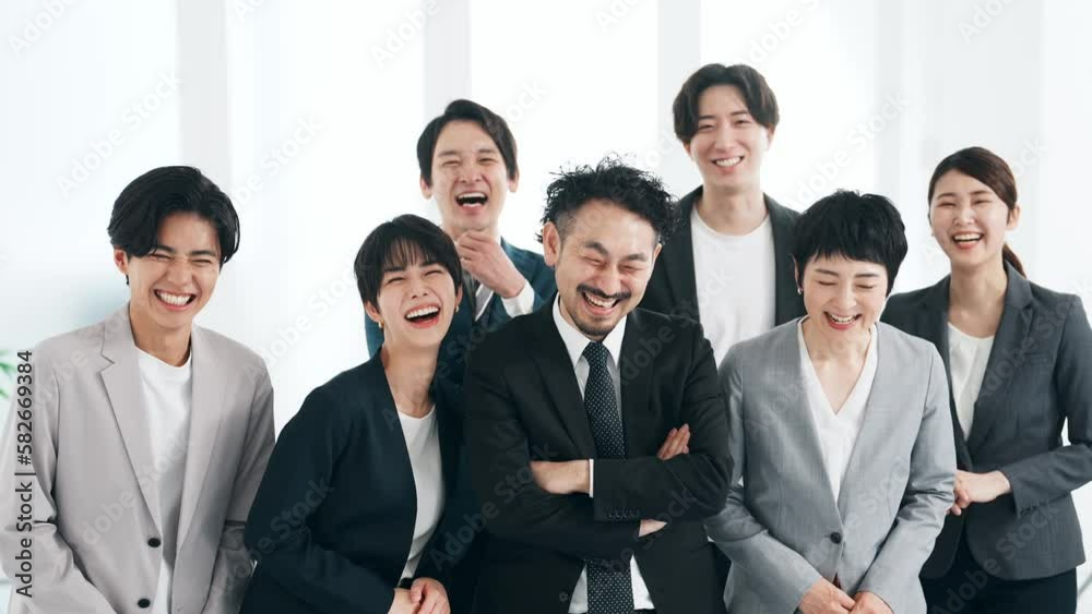 オフィスで大笑いする大勢のビジネスパーソン オフィスで大笑いする大勢のビジネスパーソン