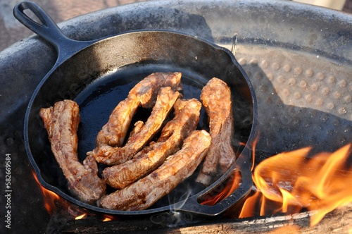 Spare ribs being cooked in a skillet