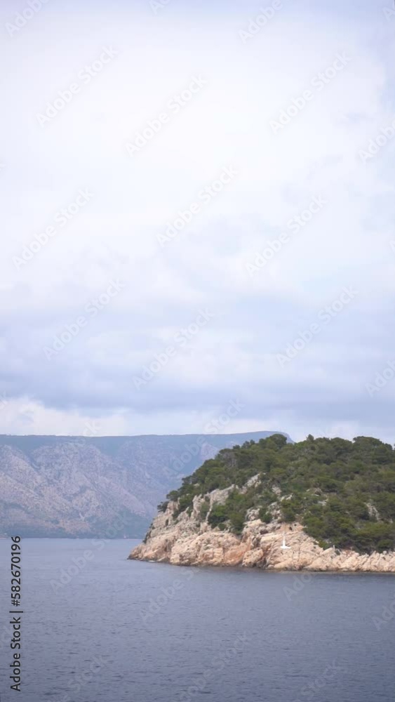 Vertical video of the Croatian islands in the vast blue Adriatic sea from a sailing boat Vertical video of the Croatian islands in the vast blue Adriatic sea from a sailing boat