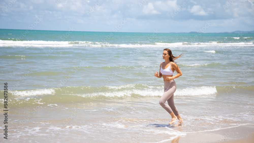 Woman running during outdoor s workout on summer beach Woman running during outdoor s workout on summer beach