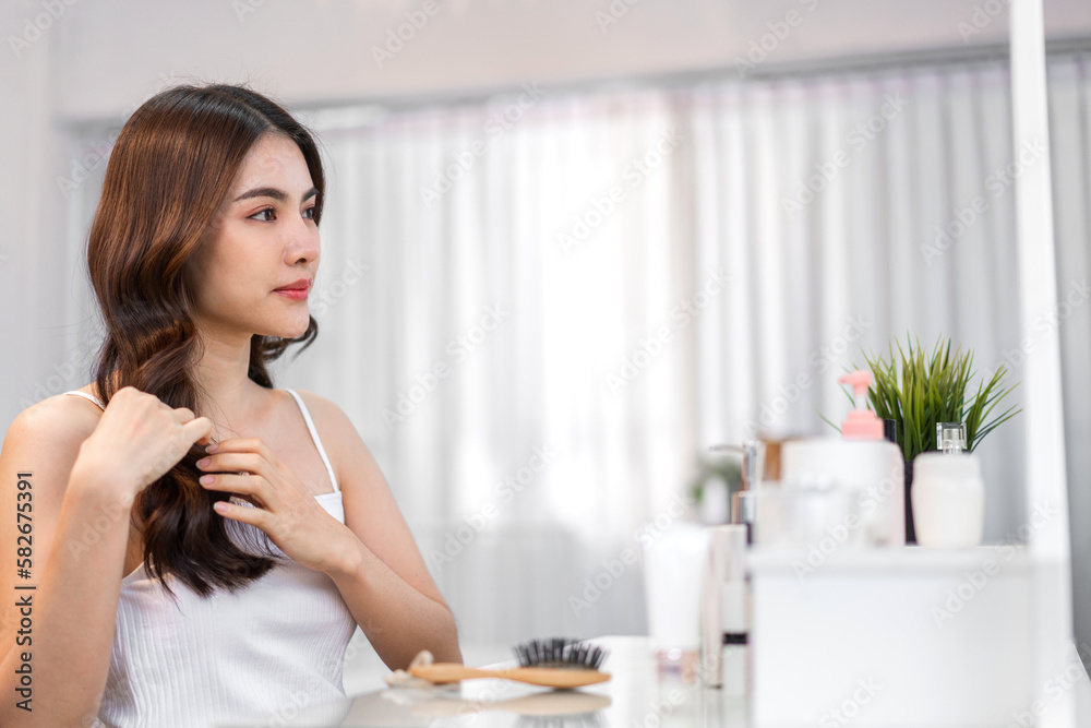 Portrait of smiling cheerful beauty pretty asian woman clean fresh healthy white skin posing smile with black long shiny straight smooth health hair looking on mirror.Haircare cosmetic Portrait of smiling cheerful beauty pretty asian woman clean fresh healthy white skin posing smile with black long shiny straight smooth health hair looking on mirror.Haircare cosmetic