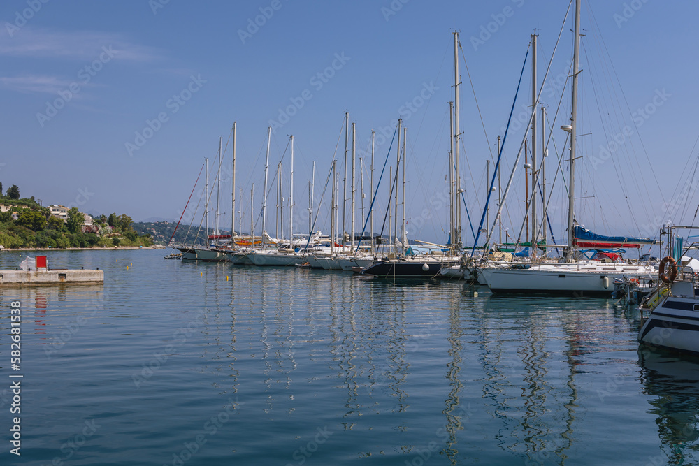 Yachts in marina of Benitses town on the Ionian Sea shore on Corfu Island, Greece