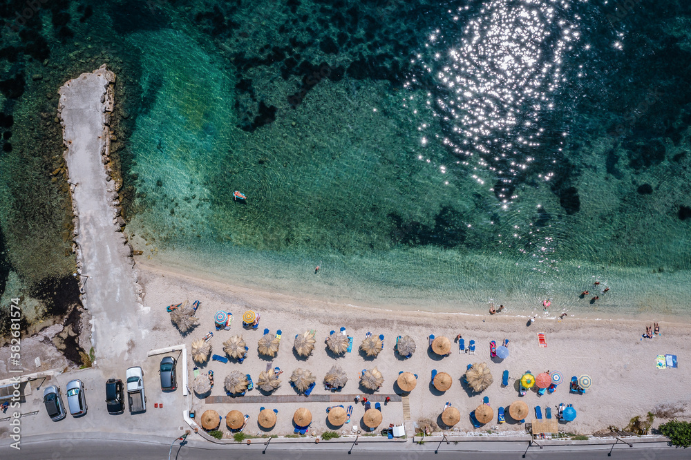 Beach in Benitses village on the Ionian Sea coast in Corfu Island, Greece