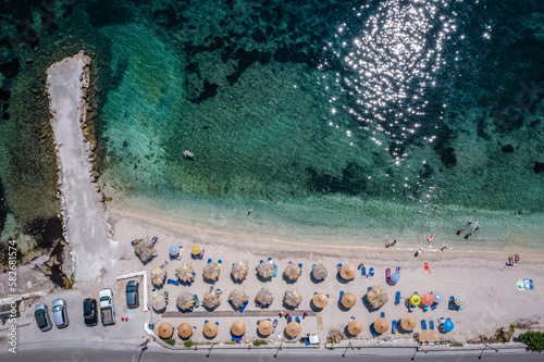 Beach in Benitses village on the Ionian Sea coast in Corfu Island, Greece