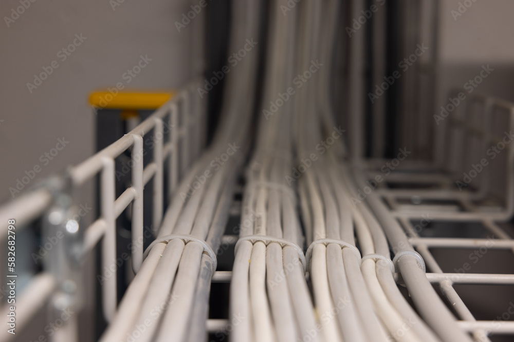 Electrical cables routed in a cable duct with a soft bokeh. Electrical cables routed in a cable duct with a soft bokeh.