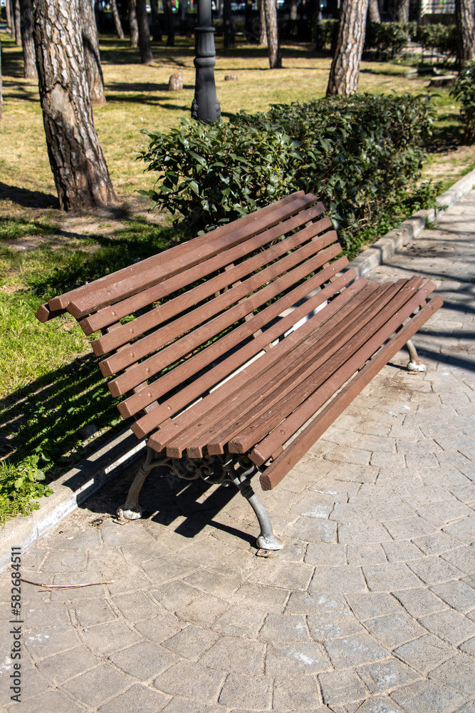 Wooden bench in a park in perspective 