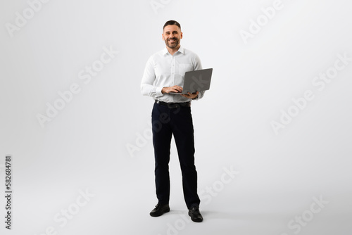 Ταπετσαρία Full length portrait of middle aged businessman using laptop computer for online