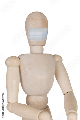 wooden mannequin doll in a medical mask isolated on white background